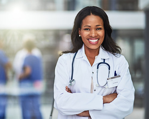 a smiling doctor crosses her arms