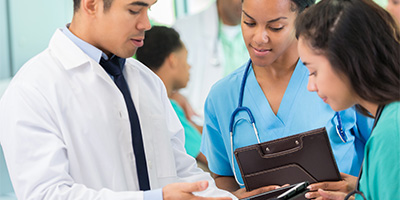 a doctor showing patients information from a tablet